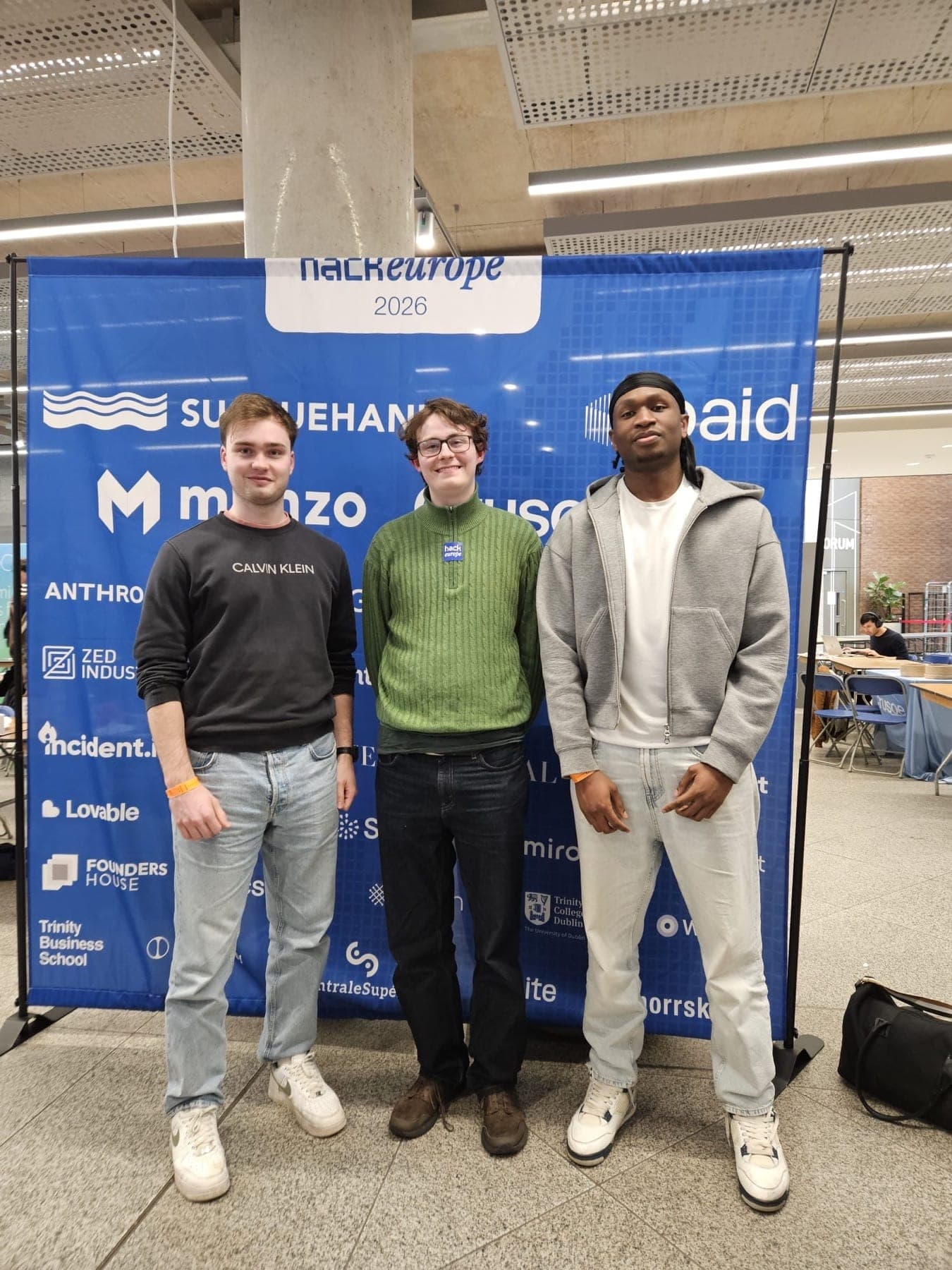The @everyone team in front of the HackEurope 2026 backdrop at Trinity College Dublin.